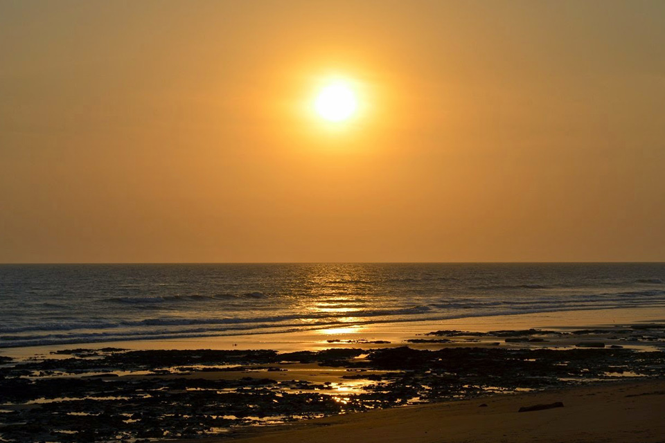 sun setting in the west horizon over pingleshwar beach