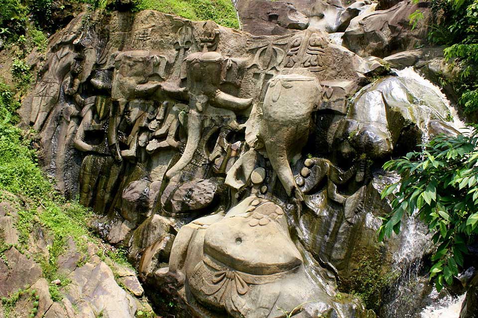 water falls and cascades through unakoti rock carvings